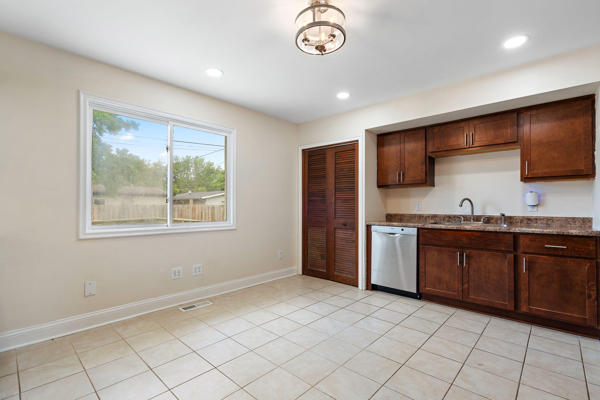 385 Riviera Court Valparaiso, IN 46385 - Photo 12 of 27 a large kitchen with granite countertop a sink and a stove top oven
