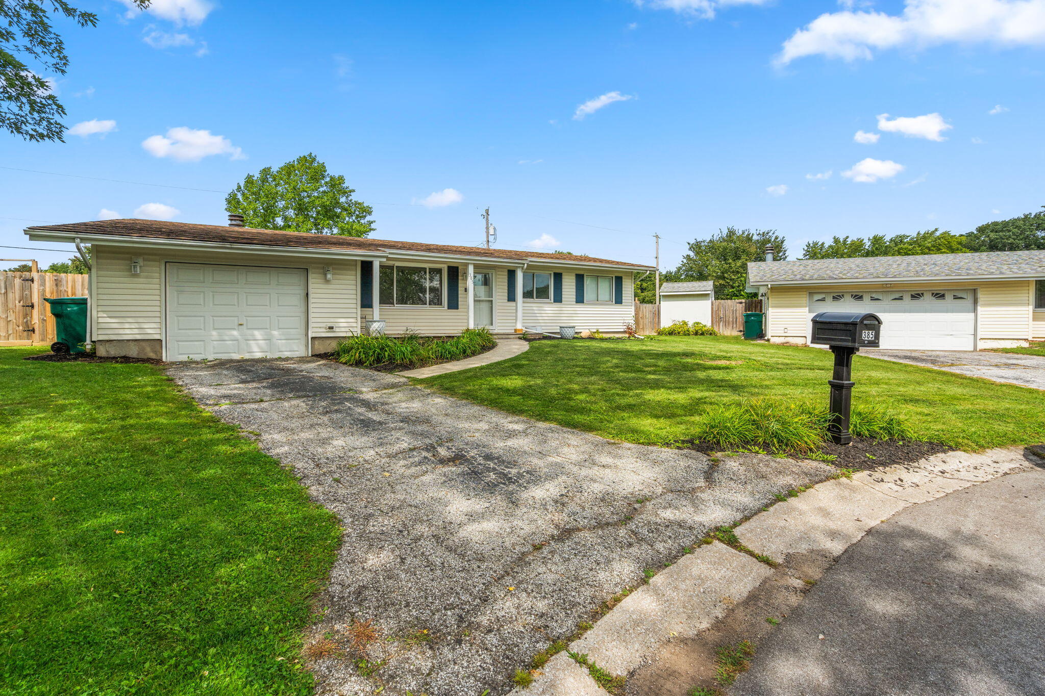 385 Riviera Court Valparaiso, IN 46385 - Photo 25 of 27 a front view of a house with a yard and garage