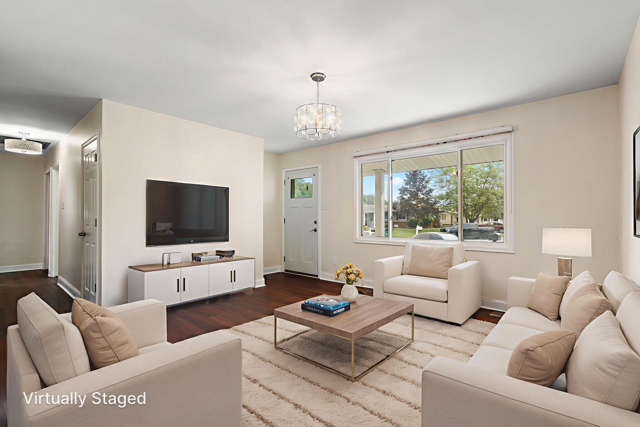 385 Riviera Court Valparaiso, IN 46385 - Photo 4 of 27 a living room with furniture a flat screen tv and a large window