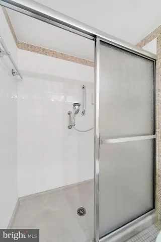 a bathroom with a glass shower door