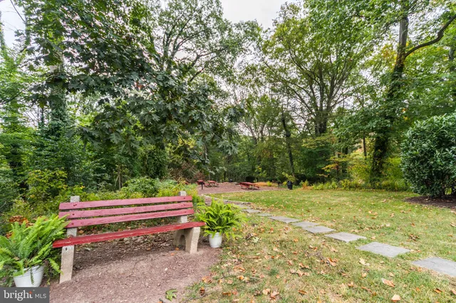 a backyard of a house with trees and outdoor seating