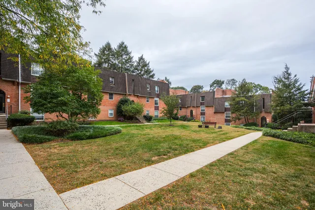 a view of a garden with a building in the background