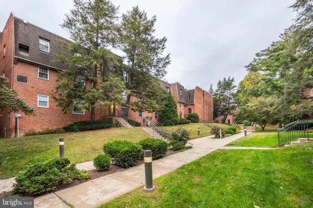 a view of a street with a building and a street sign