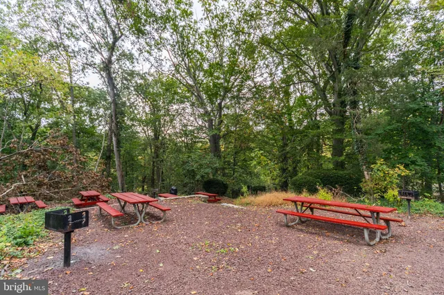a backyard of a house with fire pit and outdoor seating