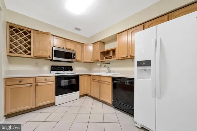 a kitchen with a sink cabinets and stainless steel appliances