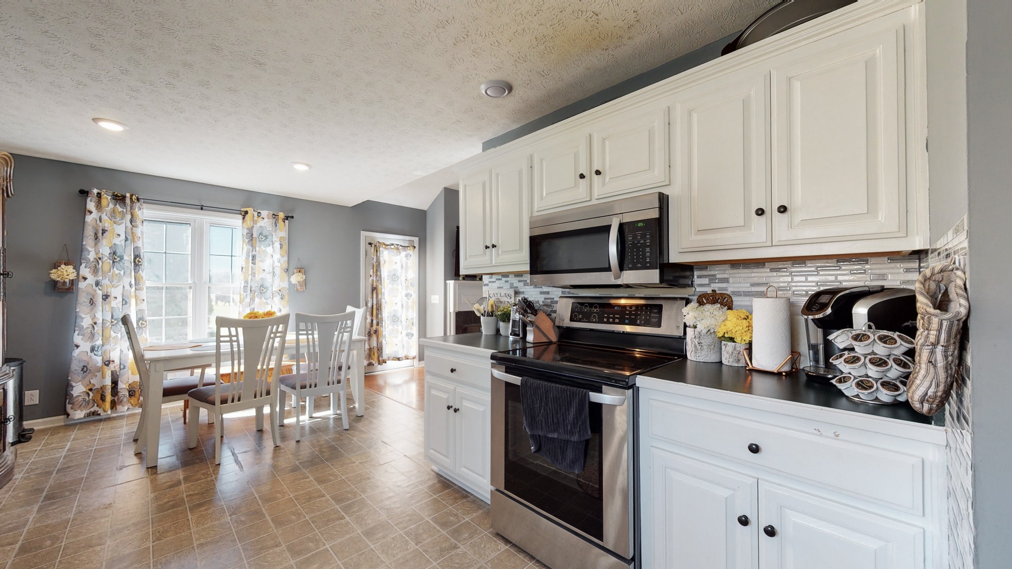 184 Foxrun Springfield, TN 37172 - Photo 14 of 20 a kitchen with white cabinets and stainless steel appliances