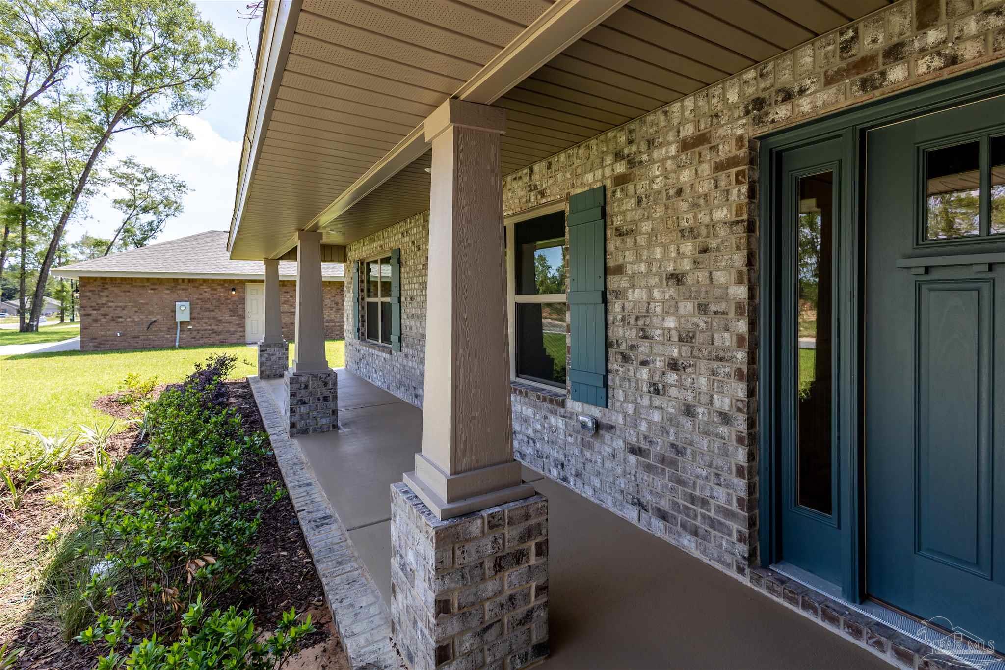 5979 Parsonage Circle Milton, FL 32570 - Photo 3 of 26 a view of a patio with table and chairs and potted plants