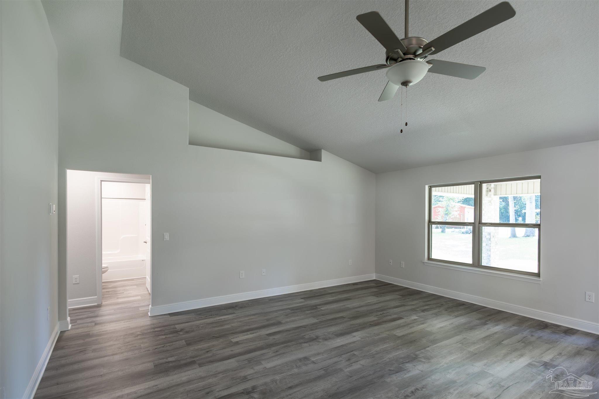 5979 Parsonage Circle Milton, FL 32570 - Photo 9 of 26 wooden floor in an empty room with a window