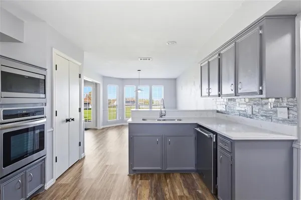 a kitchen with a sink stove and refrigerator