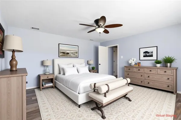a bedroom with a bed and a dresser in it