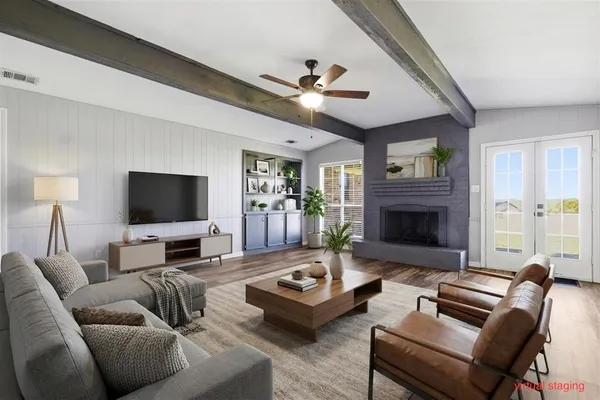 a living room with furniture fireplace and a flat screen tv