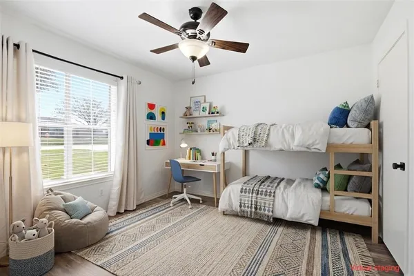 a bedroom with a bed and a window