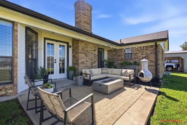 a view of a patio with couches table and chairs with garden