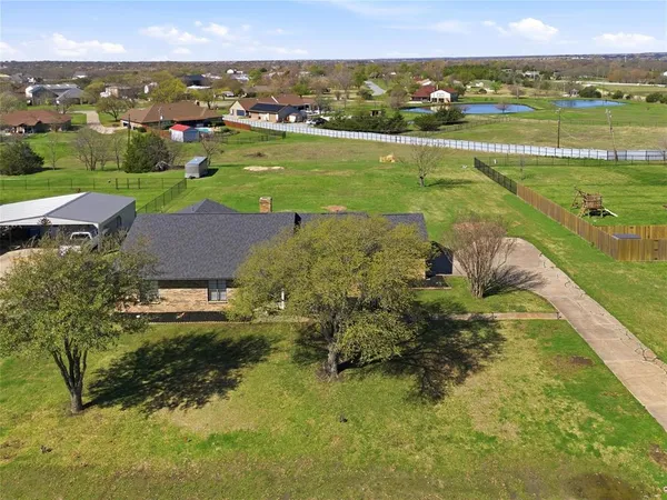 an aerial view of a houses with a yard