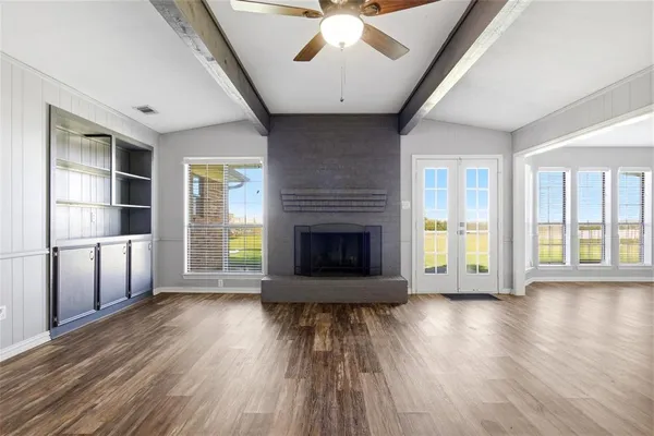 a living room with hardwood floor and a fireplace