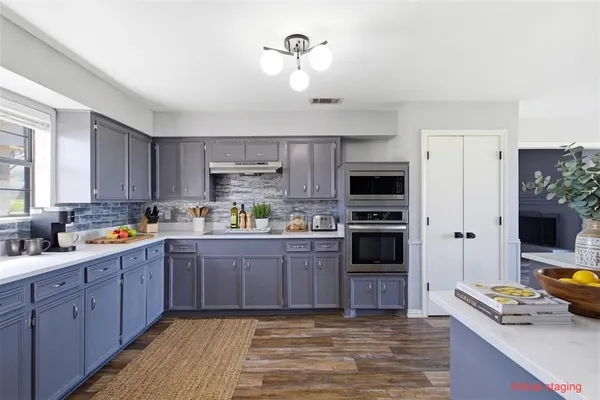 a kitchen with a refrigerator stove and microwave