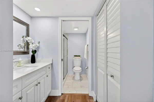 a view of a room with wooden floor and white doors