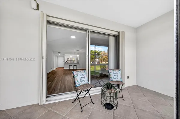a view of sign board with flower plants