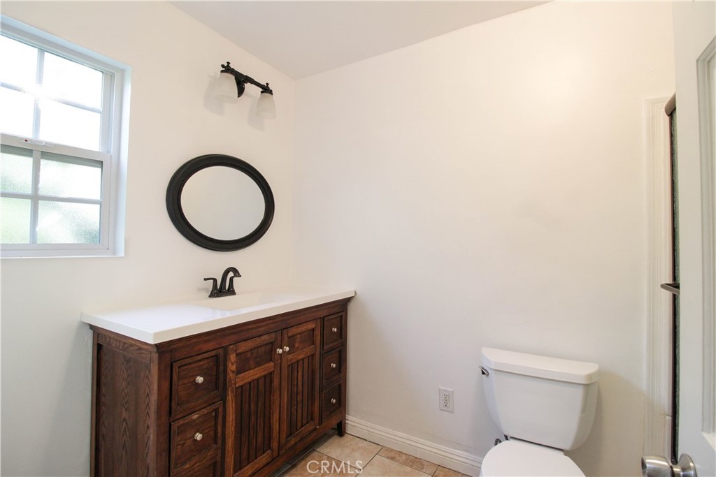 5226 Range View Avenue Los Angeles, CA 90042 - Photo 12 of 16 a bathroom with a toilet a sink and a mirror