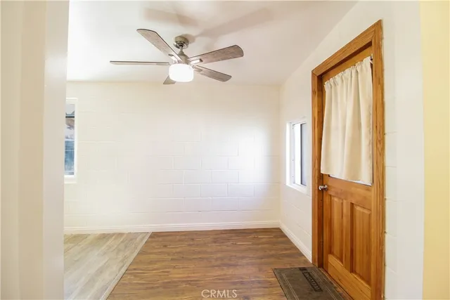 a view of a hallway with wooden floor and closet
