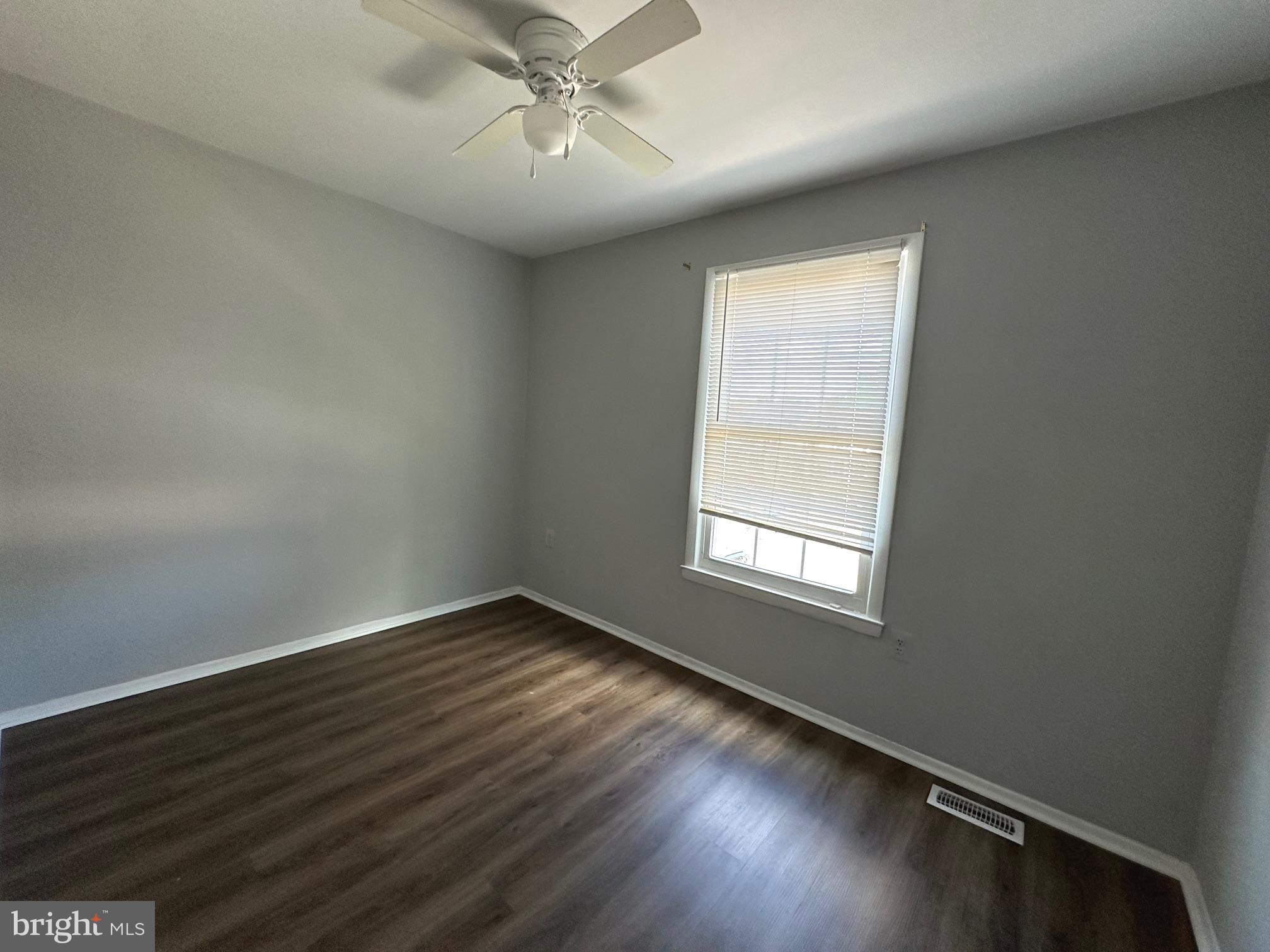 9078 McClellan Common Manassas, VA 20110 - Photo 13 of 25 an empty room with wooden floor fan and windows