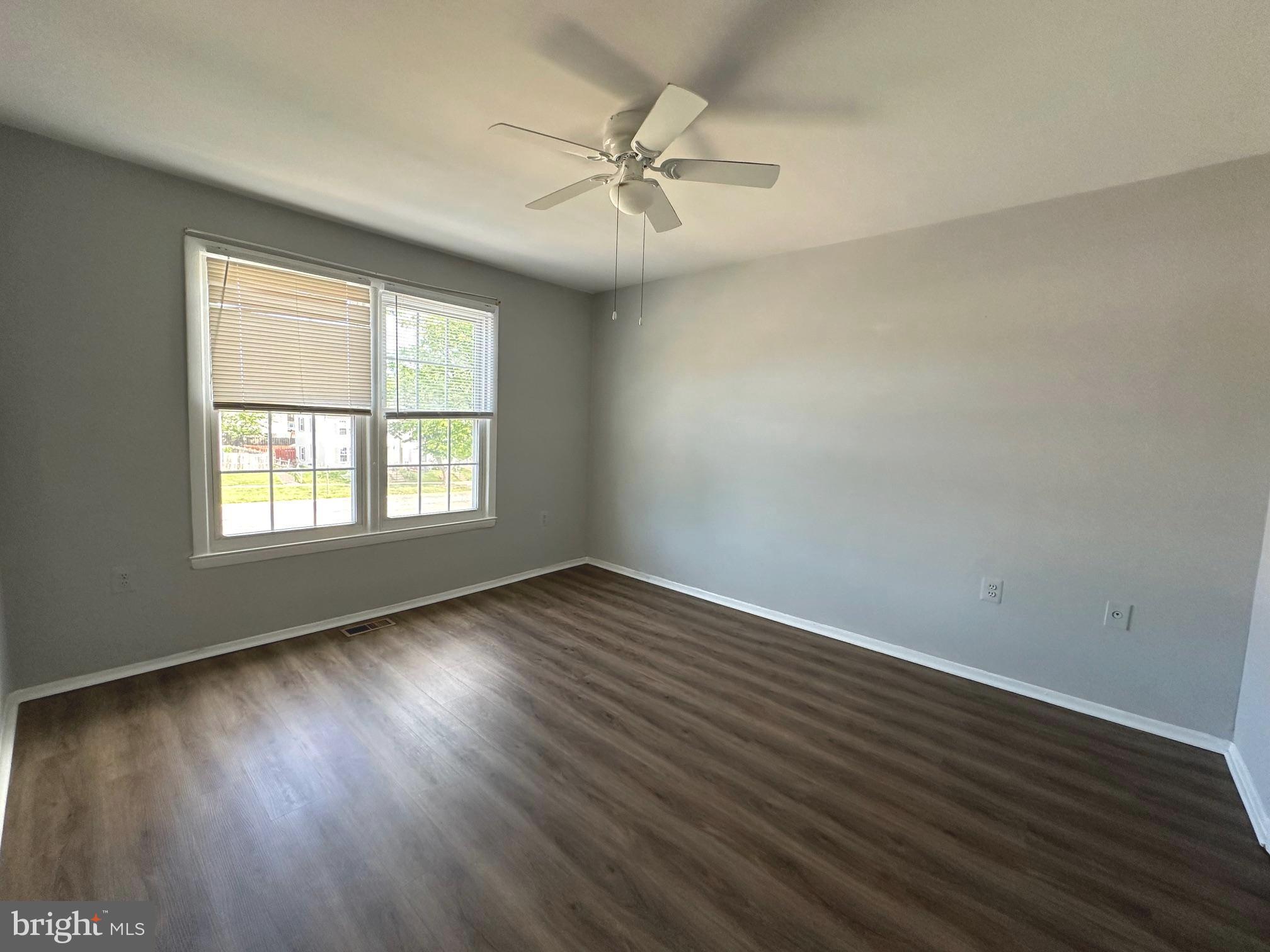 9078 McClellan Common Manassas, VA 20110 - Photo 14 of 25 an empty room with wooden floor fan and windows