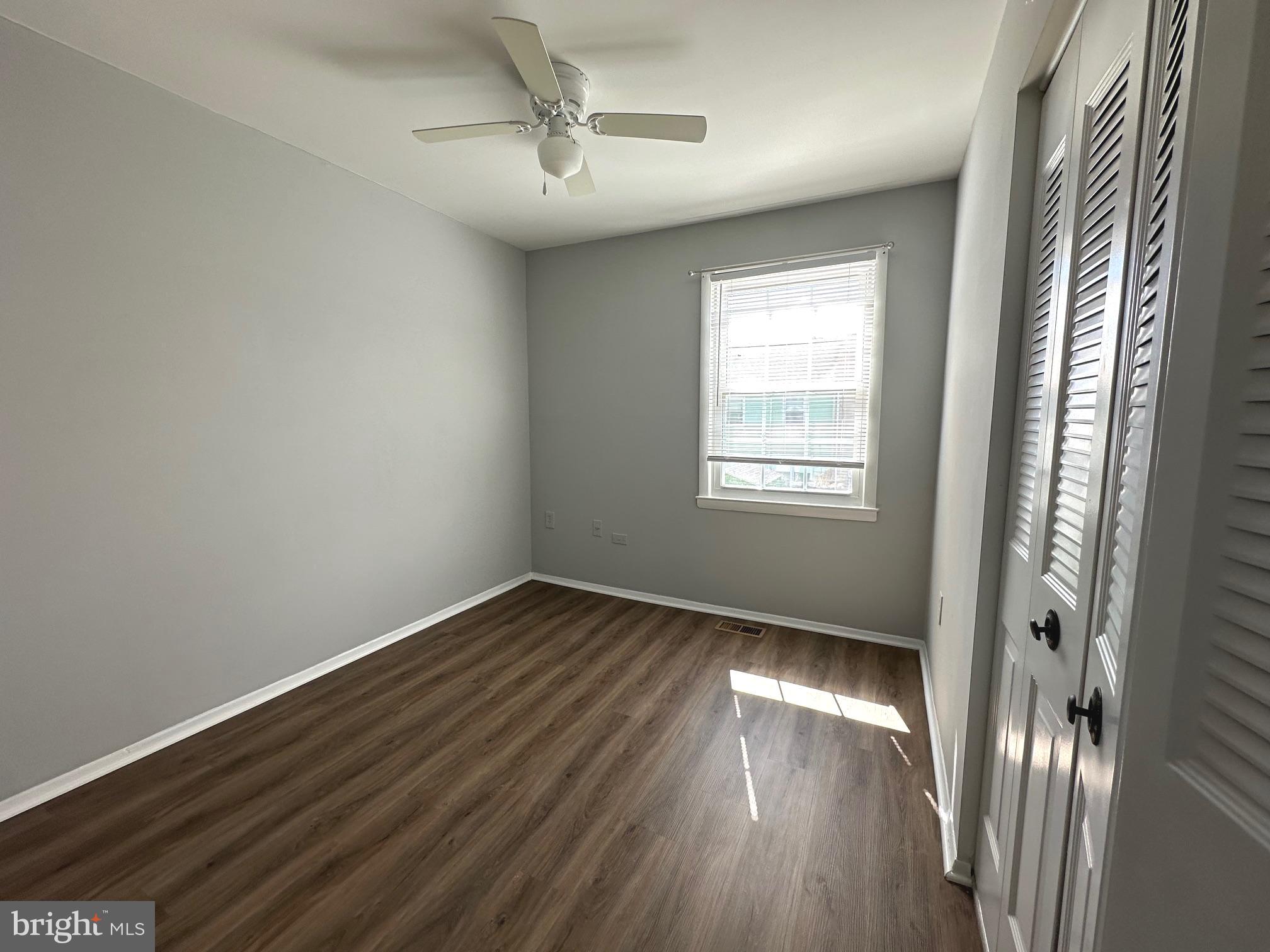 9078 McClellan Common Manassas, VA 20110 - Photo 15 of 25 a view of an empty room with wooden floor and a window