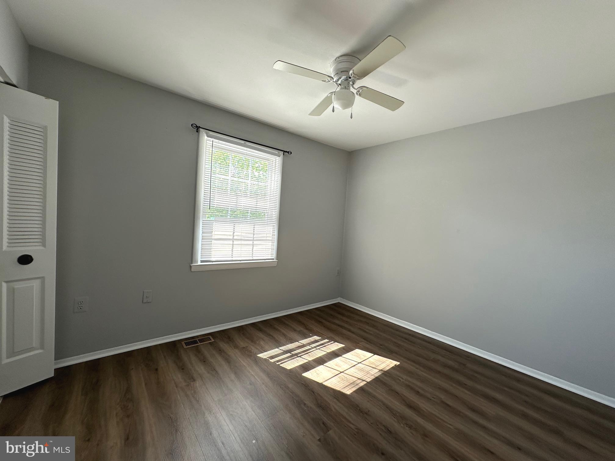 9078 McClellan Common Manassas, VA 20110 - Photo 16 of 25 a view of empty room with wooden floor and fan