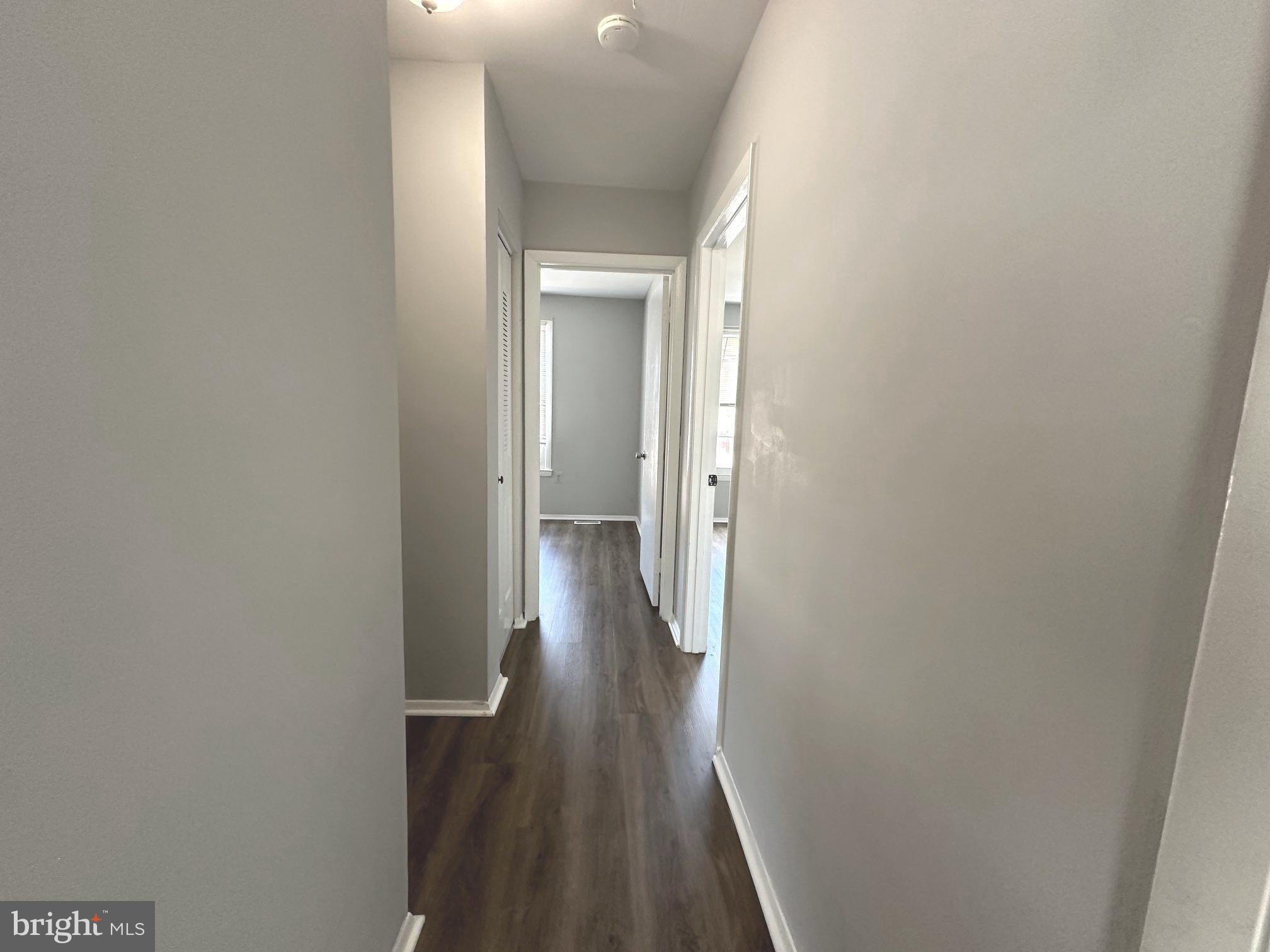 9078 McClellan Common Manassas, VA 20110 - Photo 17 of 25 a view of a hallway with wooden floor