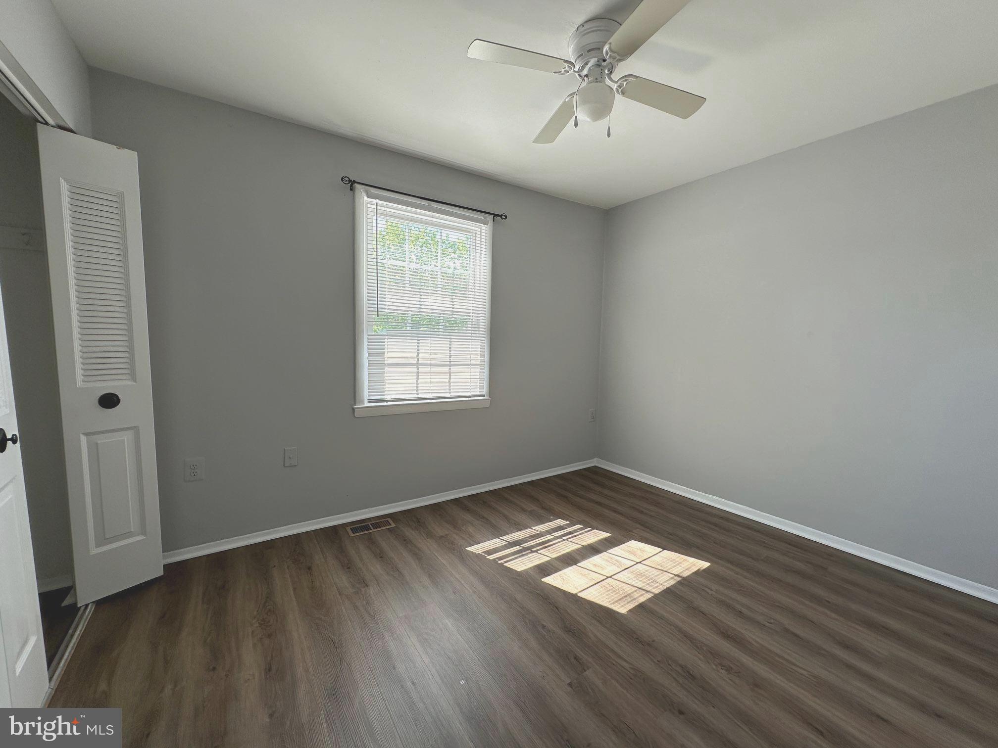 9078 McClellan Common Manassas, VA 20110 - Photo 19 of 25 a view of empty room with wooden floor and fan