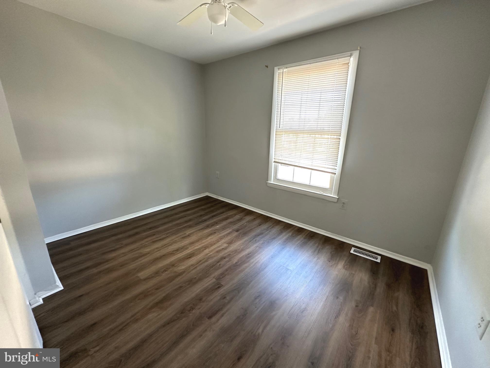 9078 McClellan Common Manassas, VA 20110 - Photo 23 of 25 an empty room with wooden floor and windows