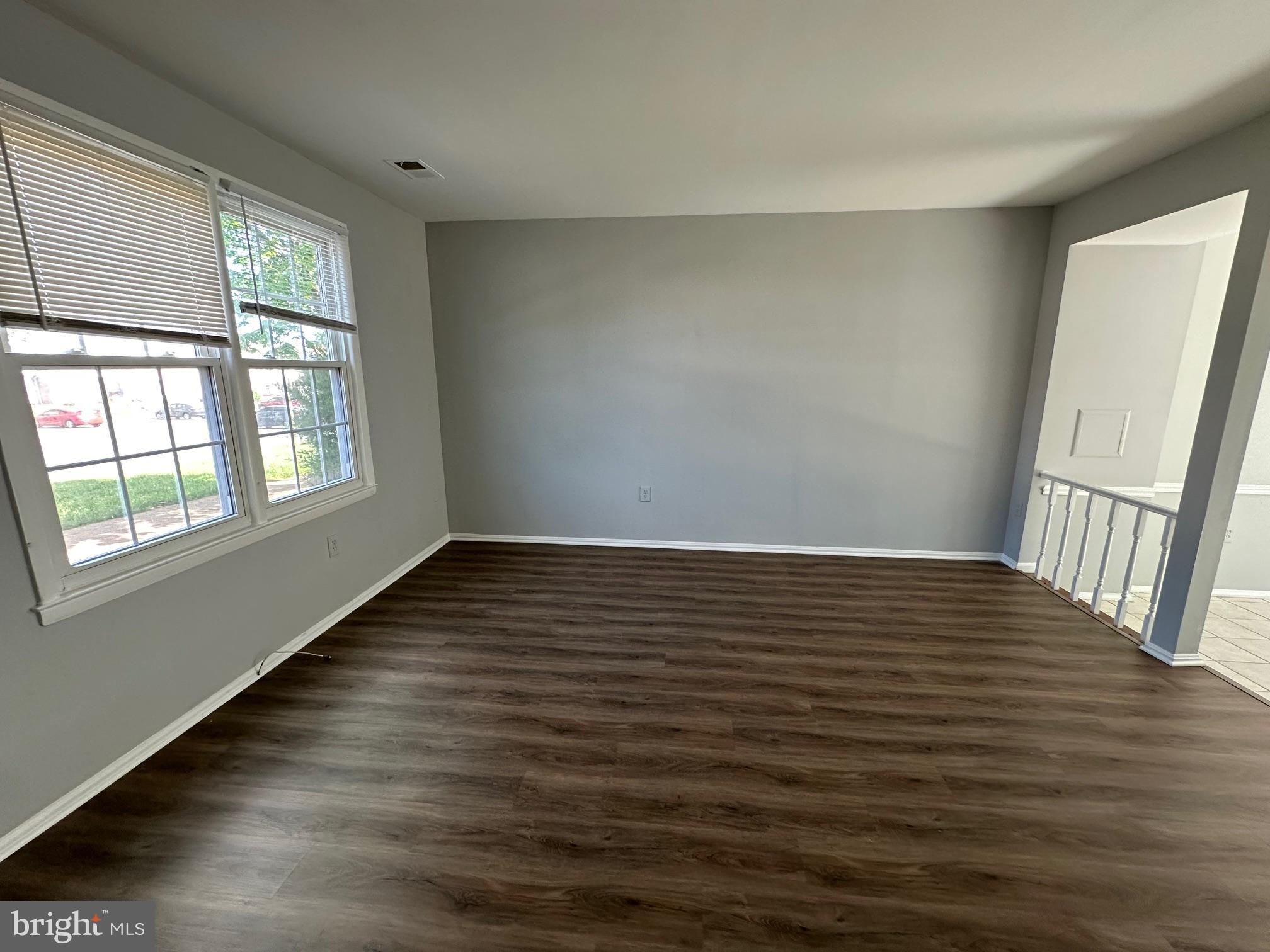 9078 McClellan Common Manassas, VA 20110 - Photo 6 of 25 a view of an empty room with wooden floor and a window