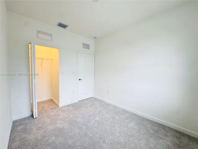 a view of an empty room and a window