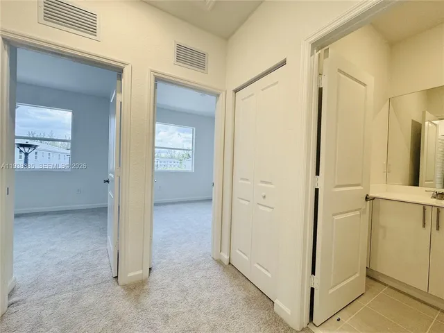 an empty room with windows and closet