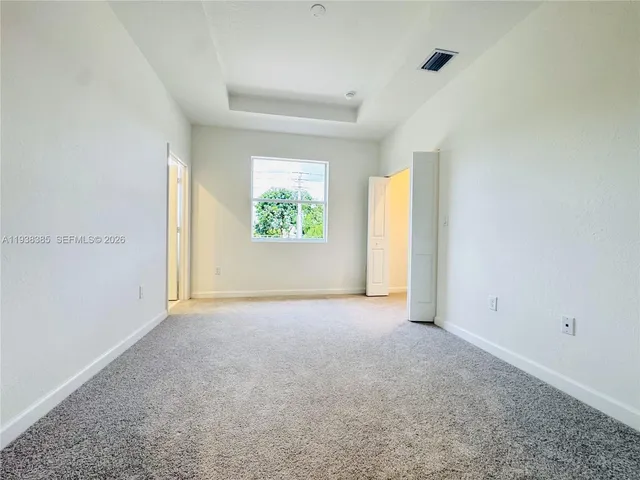 an empty room with windows and closet