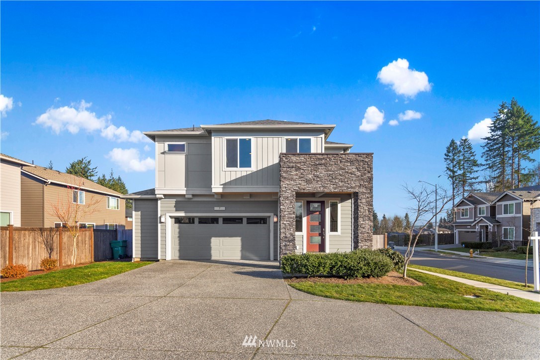 7 176th Place Southeast Bothell, WA 98012 - Photo 1 of 40 a front view of a house with a yard and garage