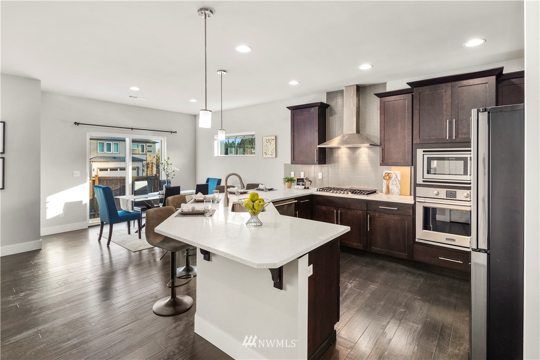 7 176th Place Southeast Bothell, WA 98012 - Photo 15 of 40 a kitchen with a sink appliances and wooden floor