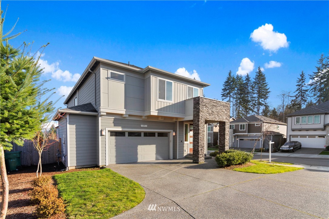7 176th Place Southeast Bothell, WA 98012 - Photo 2 of 40 a front view of a house with a yard and garage