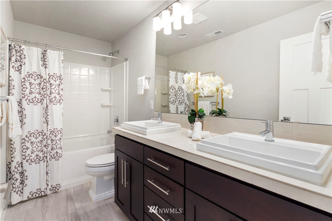 7 176th Place Southeast Bothell, WA 98012 - Photo 23 of 40 a bathroom with a double vanity sink mirror and toilet
