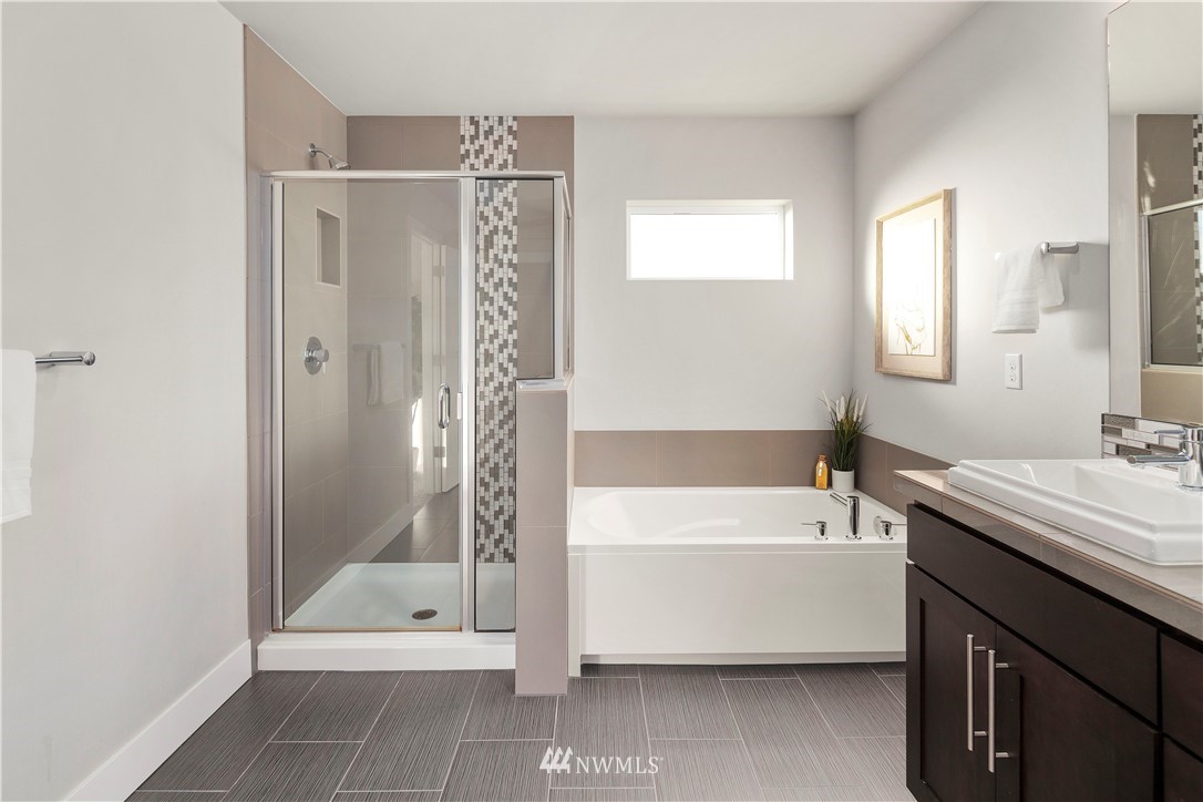 7 176th Place Southeast Bothell, WA 98012 - Photo 26 of 40 a bathroom with a tub a sink and a shower