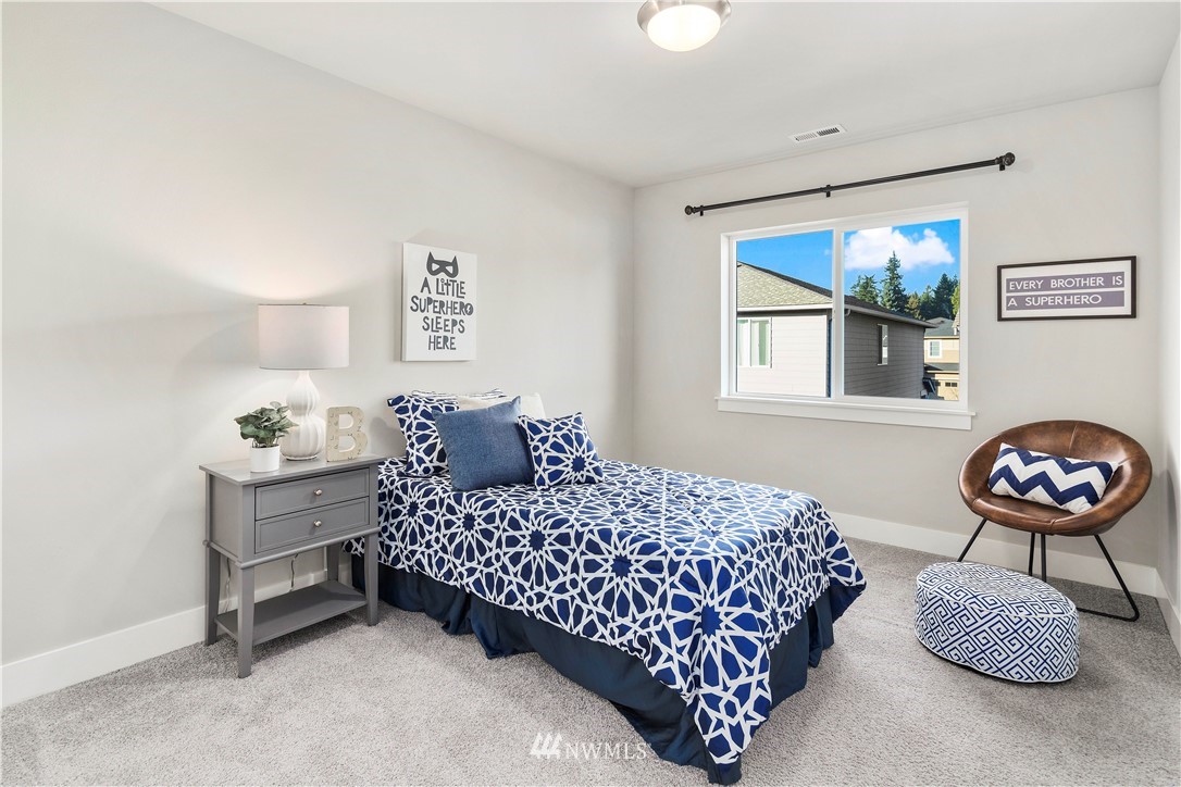 7 176th Place Southeast Bothell, WA 98012 - Photo 28 of 40 a bedroom with a bed and a lamp on dresser