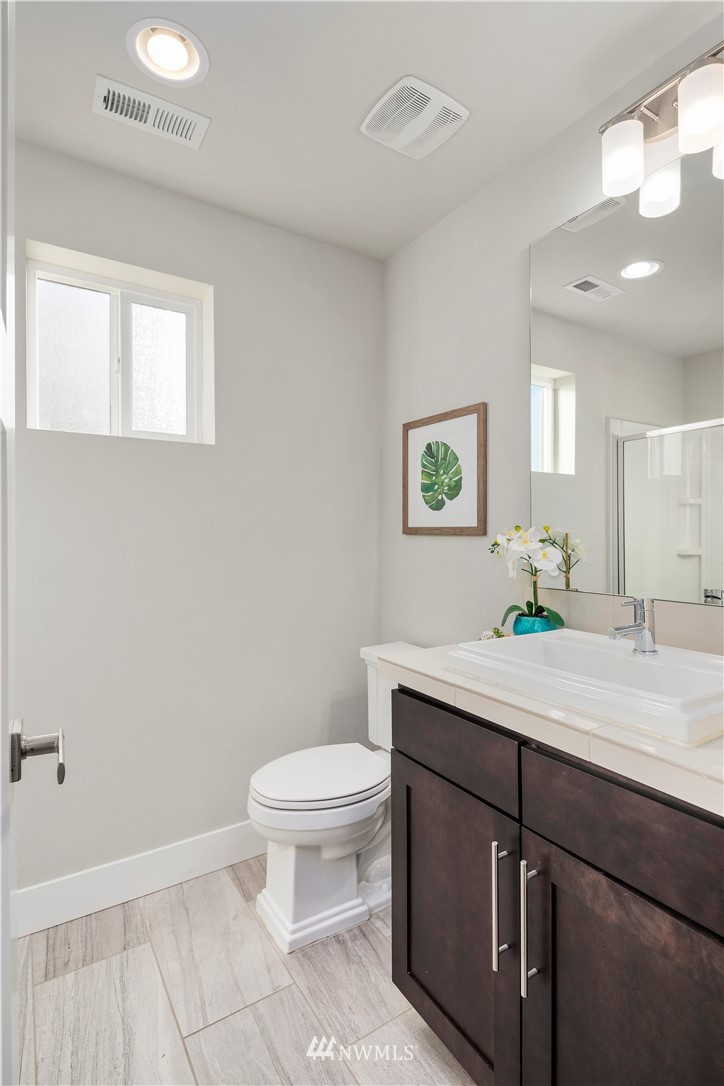 7 176th Place Southeast Bothell, WA 98012 - Photo 30 of 40 a bathroom with a sink a toilet and a mirror