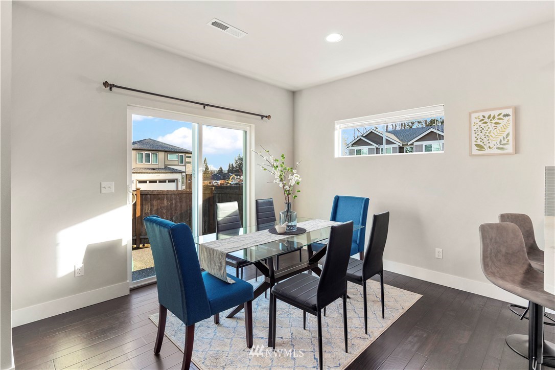 7 176th Place Southeast Bothell, WA 98012 - Photo 9 of 40 a view of a dining room with furniture window and wooden floor