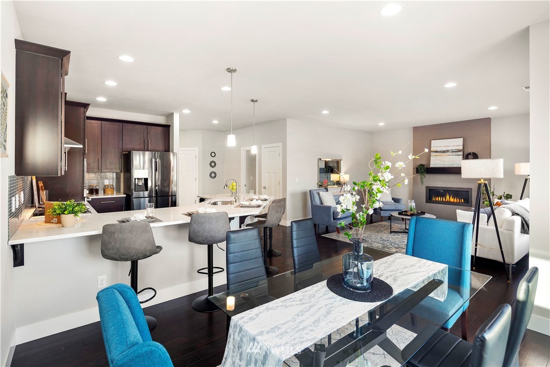 7 176th Place Southeast Bothell, WA 98012 - Photo 10 of 40 a kitchen with a dining table chairs kitchen view and living room