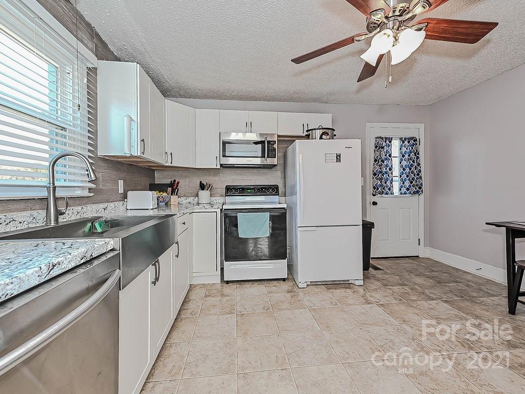 408 West Sandy Ridge Road Monroe, NC 28112 - Photo 6 of 21 a kitchen with a refrigerator a sink and dishwasher