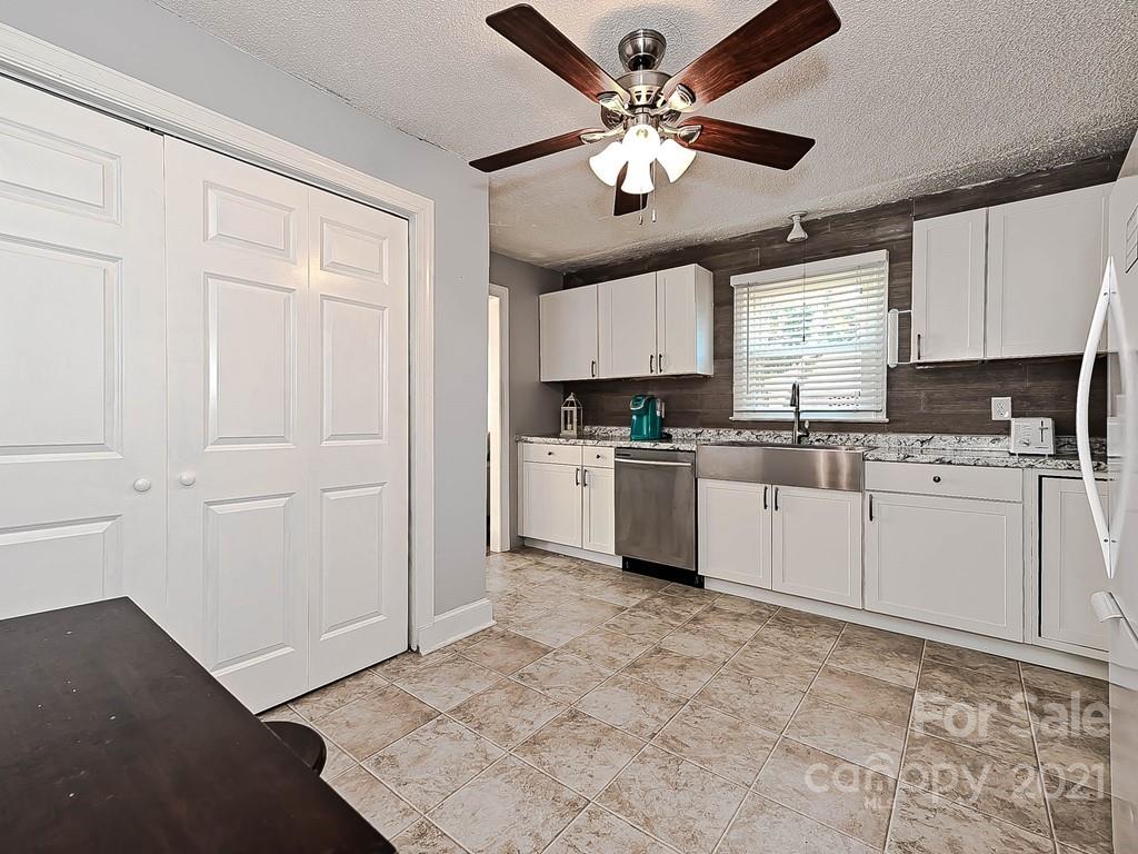 408 West Sandy Ridge Road Monroe, NC 28112 - Photo 9 of 21 a kitchen with cabinets a sink and white stainless steel appliances