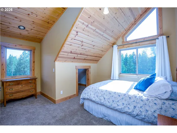 a bedroom with a large bed and a large window