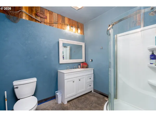 a bathroom with a toilet a sink and mirror