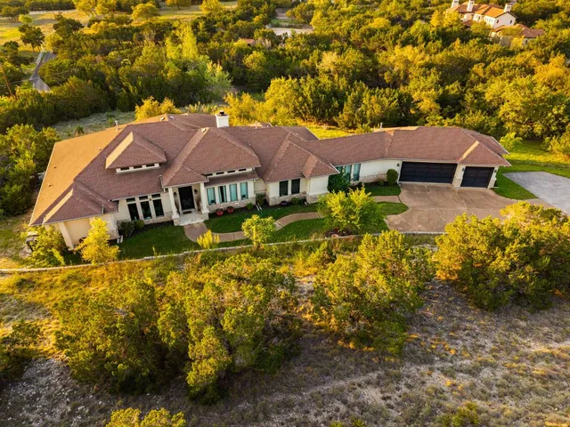 a aerial view of a house with a yard and sitting area