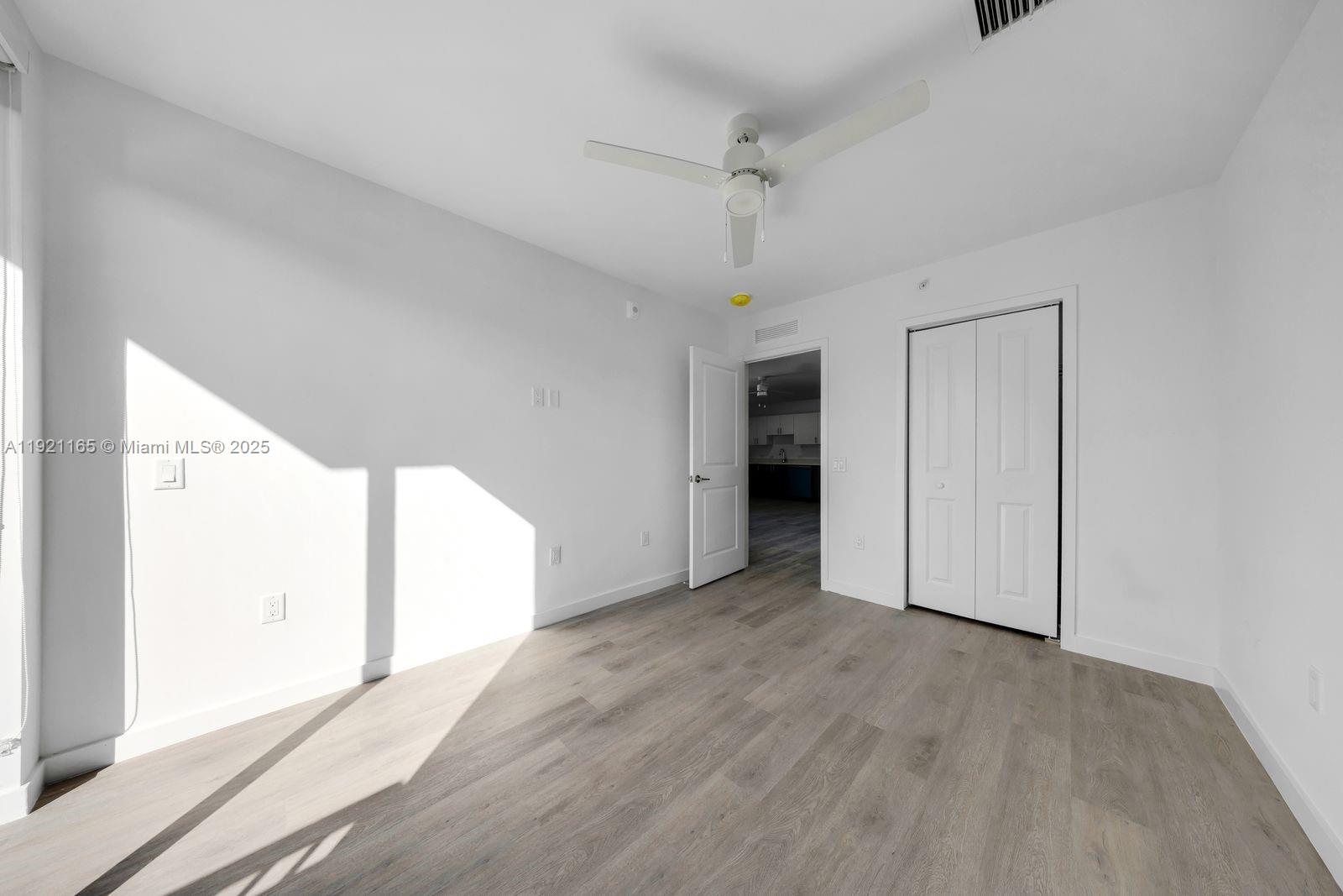 20 Northeast 19th Avenue, Unit 201 Pompano Beach, FL 33060 - Photo 12 of 25 a view of empty room with wooden floor and window